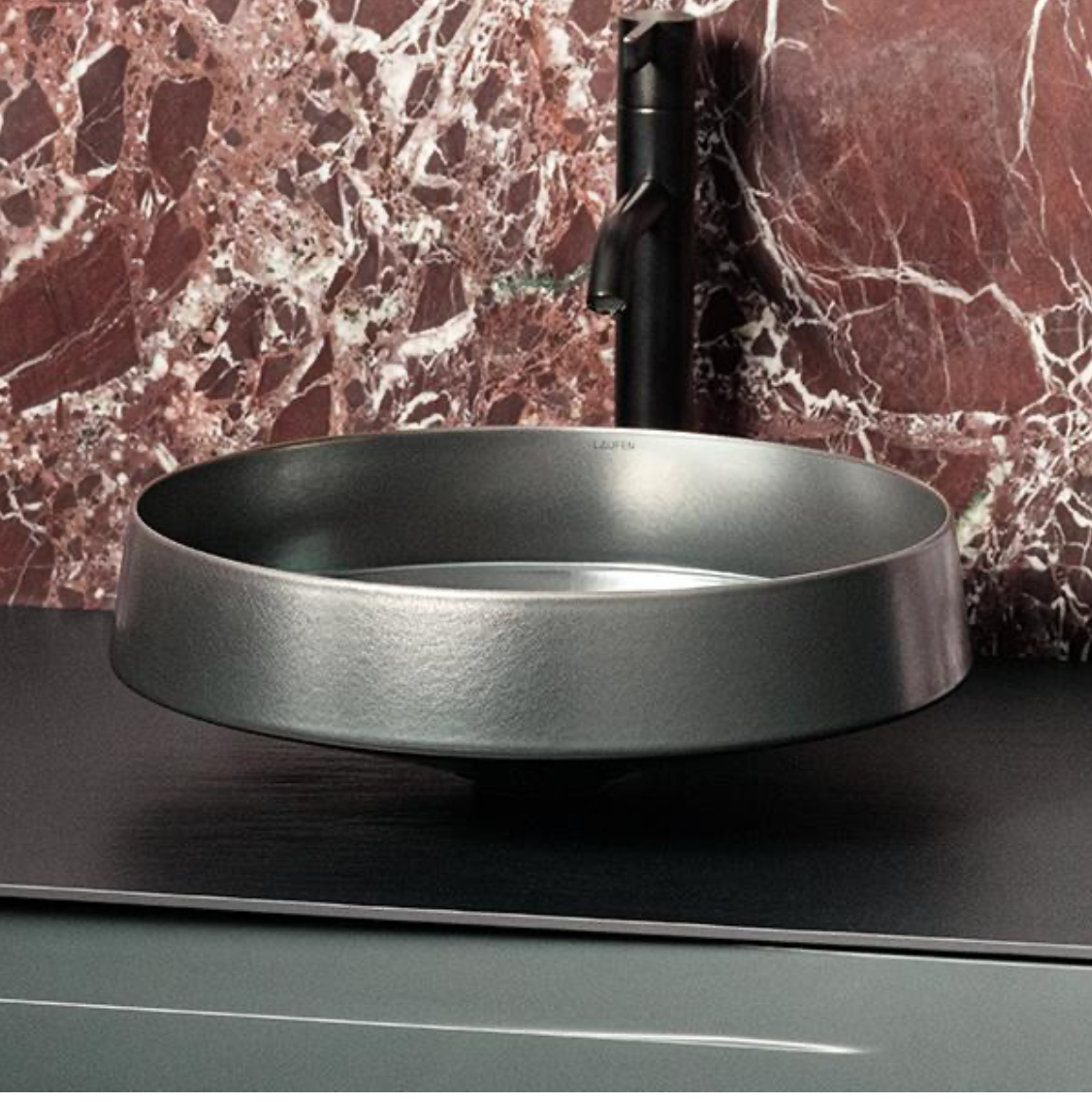 Laufen Vitreon Steel vessel basin with matte black faucet on red marble