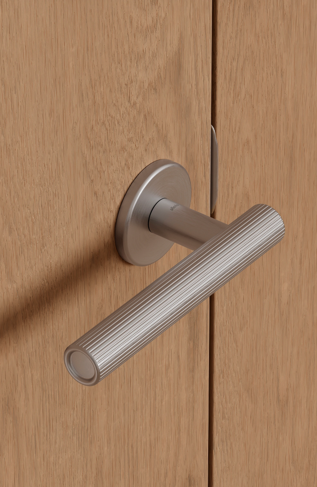 Viefe ribbed satin nickel lever handle on oak door